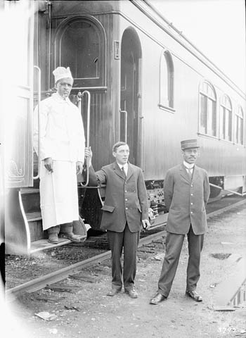 grand-trunk-pacific-railway-chef-and-porters-standing-beside-the-train-1914